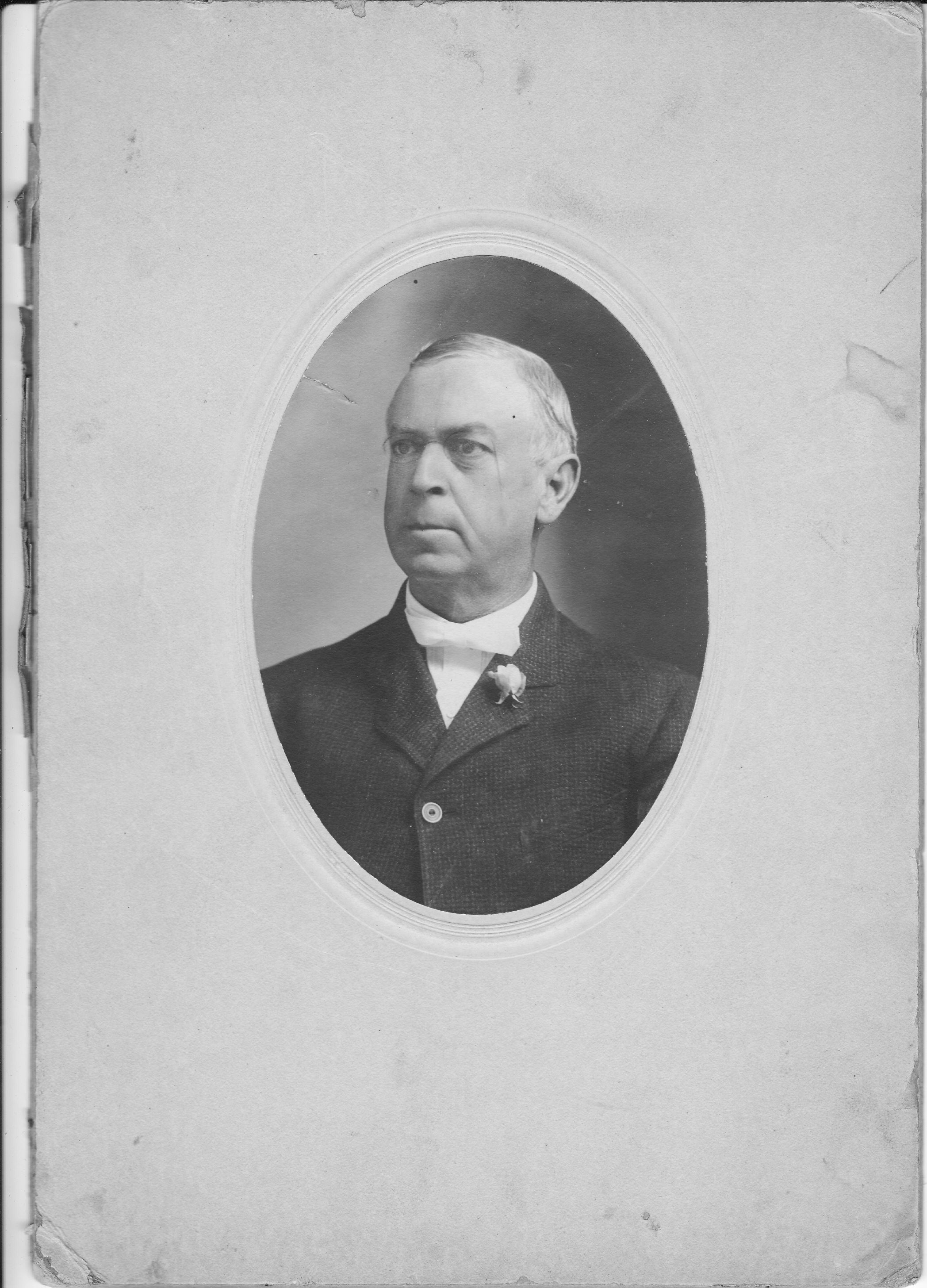 Black-and-white portrait of Jabe G. Smyth wearing a dark suit, white bow tie, and boutonniere.
